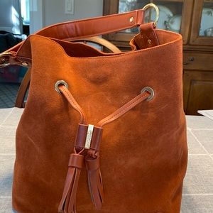 Spartina Suede,draw string bucket bag. Terracotta in color.